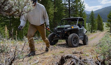 Man pulling out the winch cable on his General XP 1000