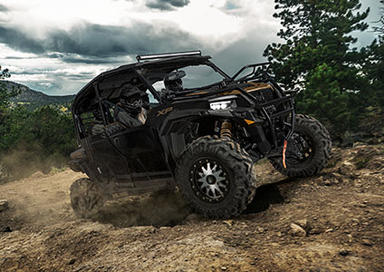 Polaris GENERAL XP 4 1000 with lock & ride storage installed driving over rocky terrain