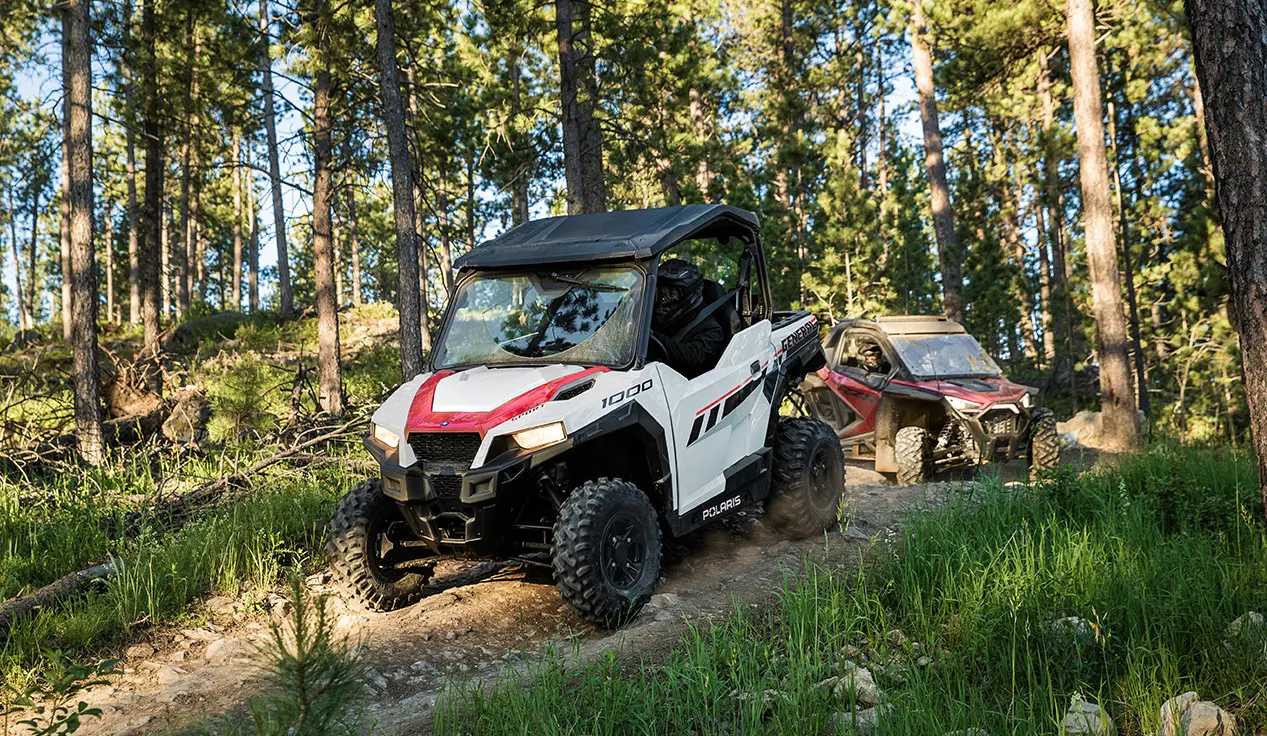 white general 1000 side by side leading a RZR on a trail