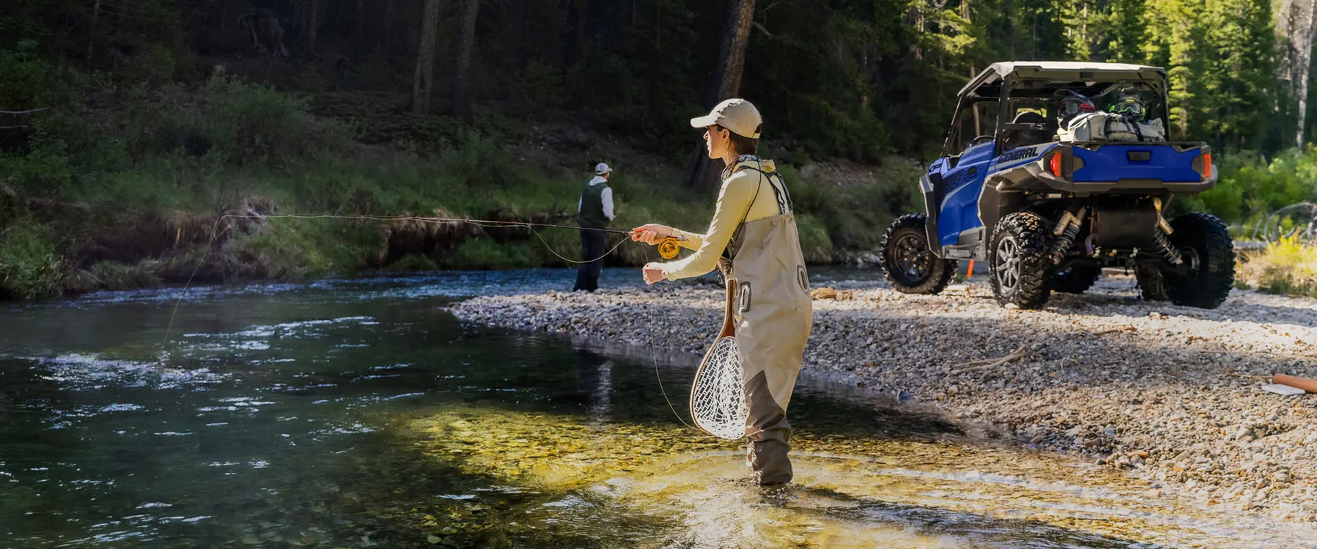 people fishing in a riverbed near their general xp 1000 side by side