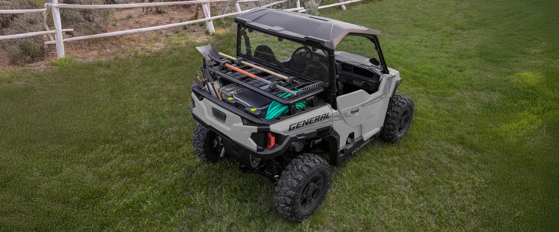 Aerial view of a 2026 Polaris GENERAL crossover side-by-side with accessories loaded on the cargo box area.