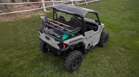 Aerial view of a 2026 Polaris GENERAL crossover side-by-side with accessories loaded on the cargo box area.