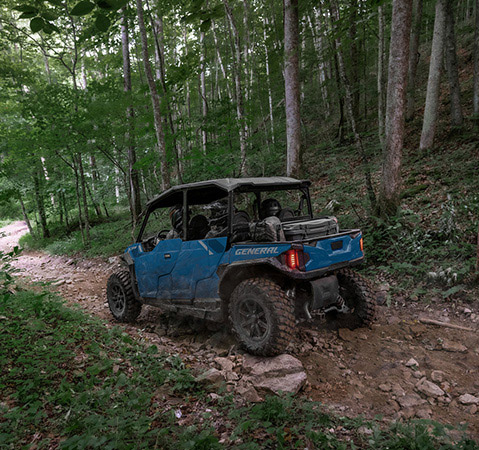 Rear view of a 2026 Polaris GENERAL XP 4 1000 crossover side-by-side on a trail showcasing it's Walker Evans Velocity Series shocks.