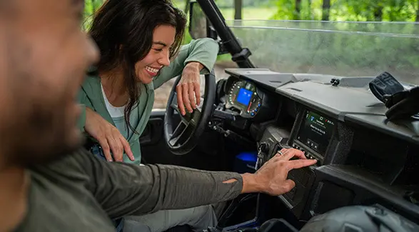 Closeup of the front end and illuminated headlights of a 2026 Polaris GENERAL XP 1000 crossover side-by-side.