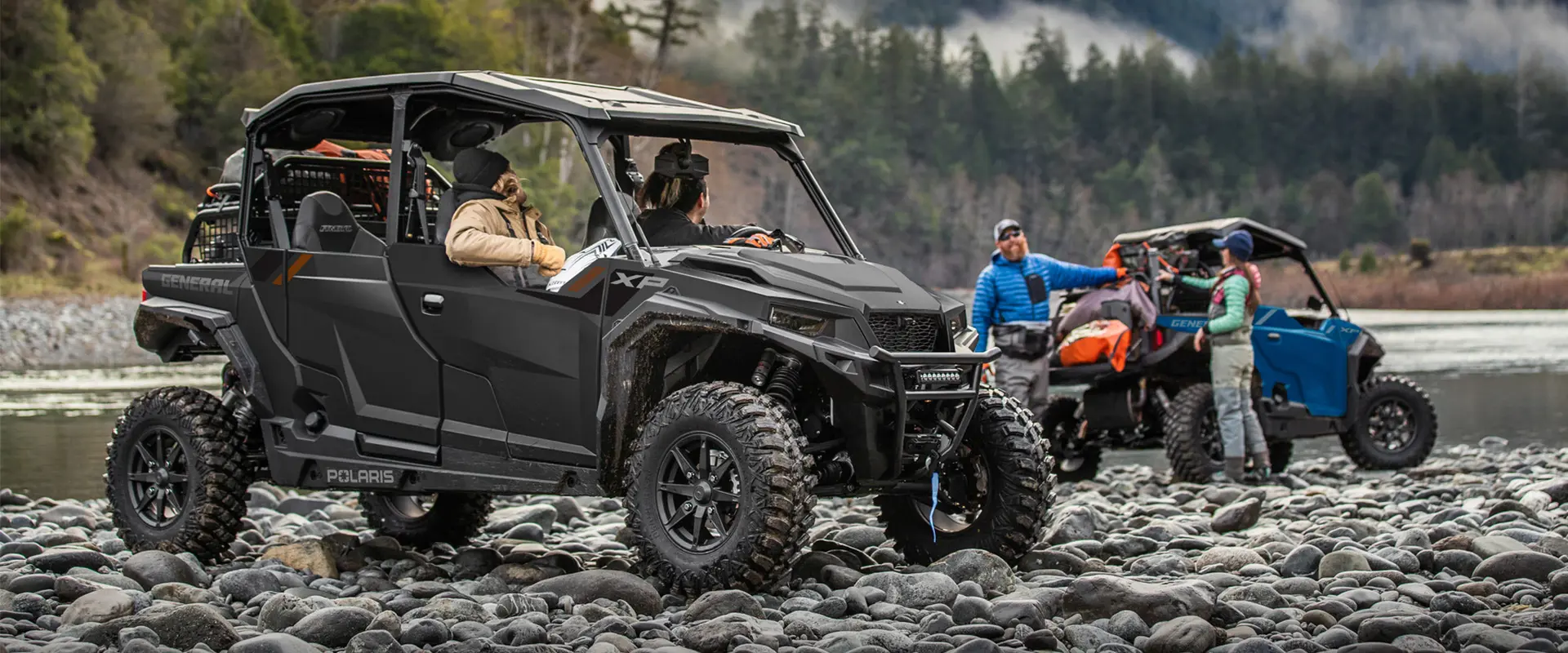 2 people in a 2026 Polaris GENERAL XP 4 1000 crossover side-by-side chatting with 2 other people near their 2026 Polaris GENERAL XP 1000.