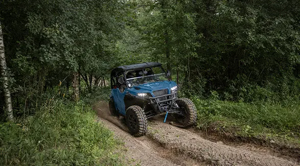 A 2026 Polaris GENERAL XP 4 1000 crossover side-by-side cruising on a trail.