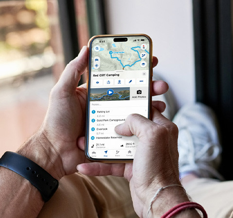 A person using the RIDE COMMAND app to plan a future ride.