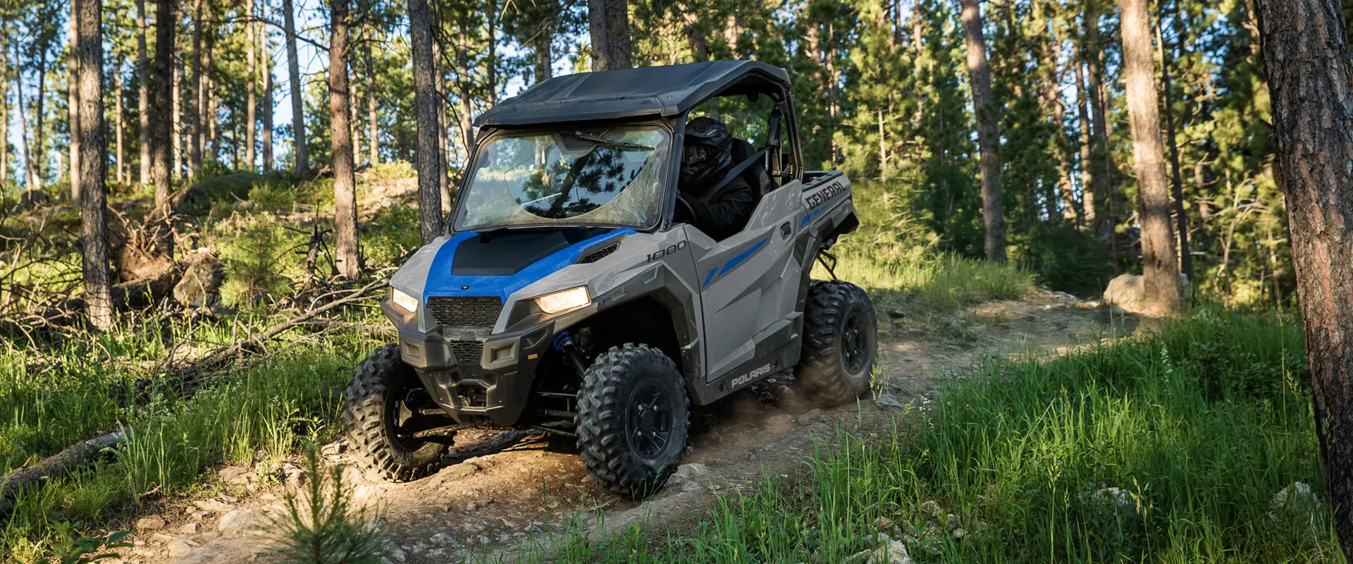 A 2027 Polaris GENERAL 1000 side-by-side descending a rocky hill.