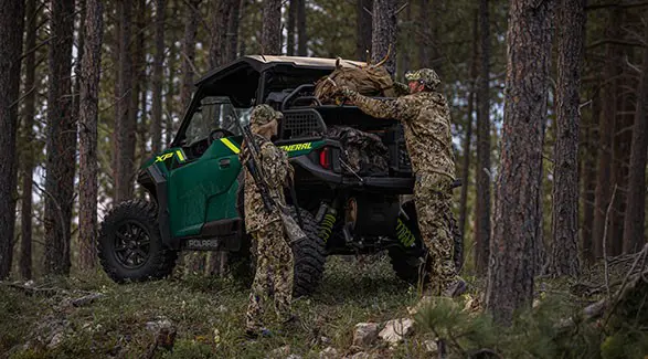 2 hunters unloaded gear from a cargo rack on a 2027 Polaris GENERAL XP 1000 SxS.