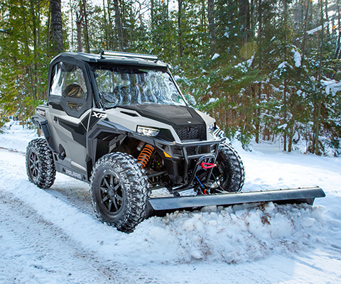 A General removing the snow frrom the road using a frontal plow attachment