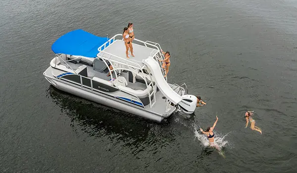 girls using the slide on a godfrey monaco sundeck pontoon