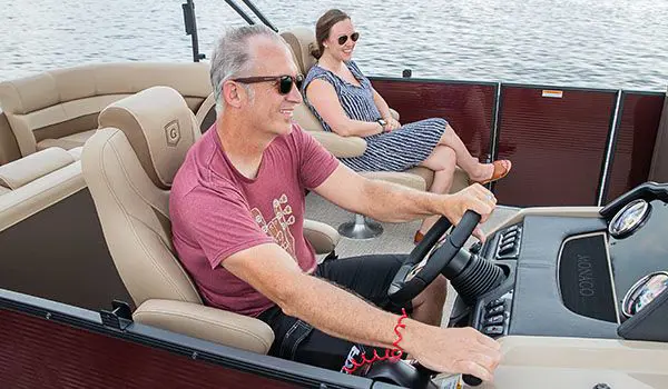 man driving a godfrey monaco split bench pontoon