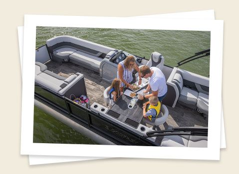 family making lunch on a table on a godfrey monaco entertainment pontoon
