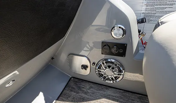speaker and 12 volt plug-in on the helm on a godfrey monaco entertainment pontoon