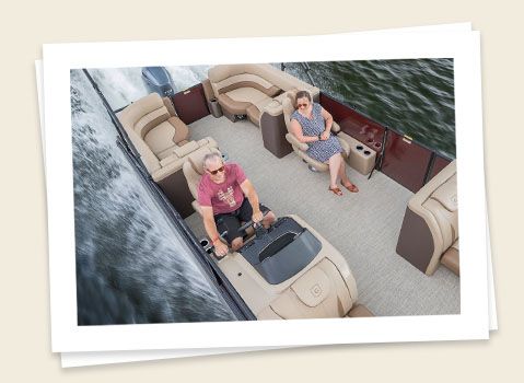 2 riders enjoying a float in a godfrey monaco split bench pontoon
