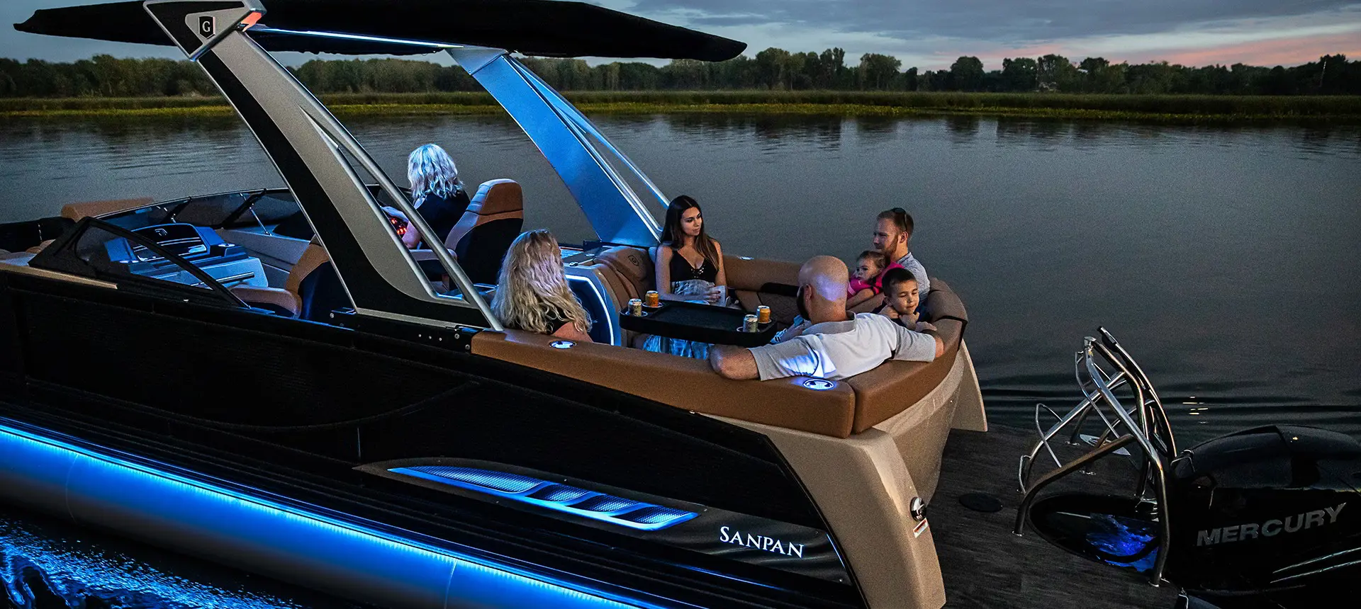 A family relaxing on their Sanpan Windshield in the night