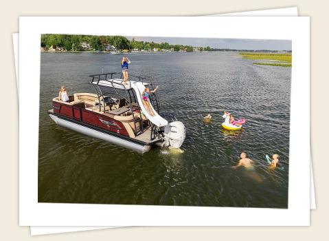 family having fun at the lake with their Godfrey pontoon