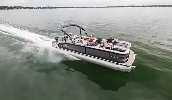 family speeding across a lake on a godfrey aquapatio entertainment pontoon