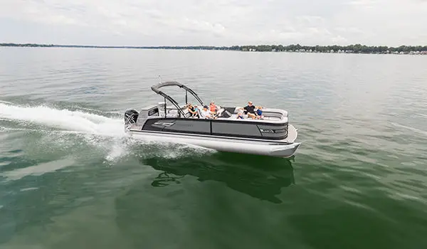 side view of a godfrey aquapatio entertainment pontoon on a lake