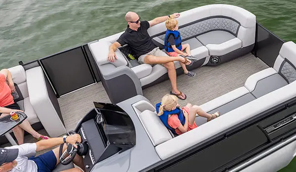 family sitting on the bow seating on a godfrey aquapatio entertainment pontoon