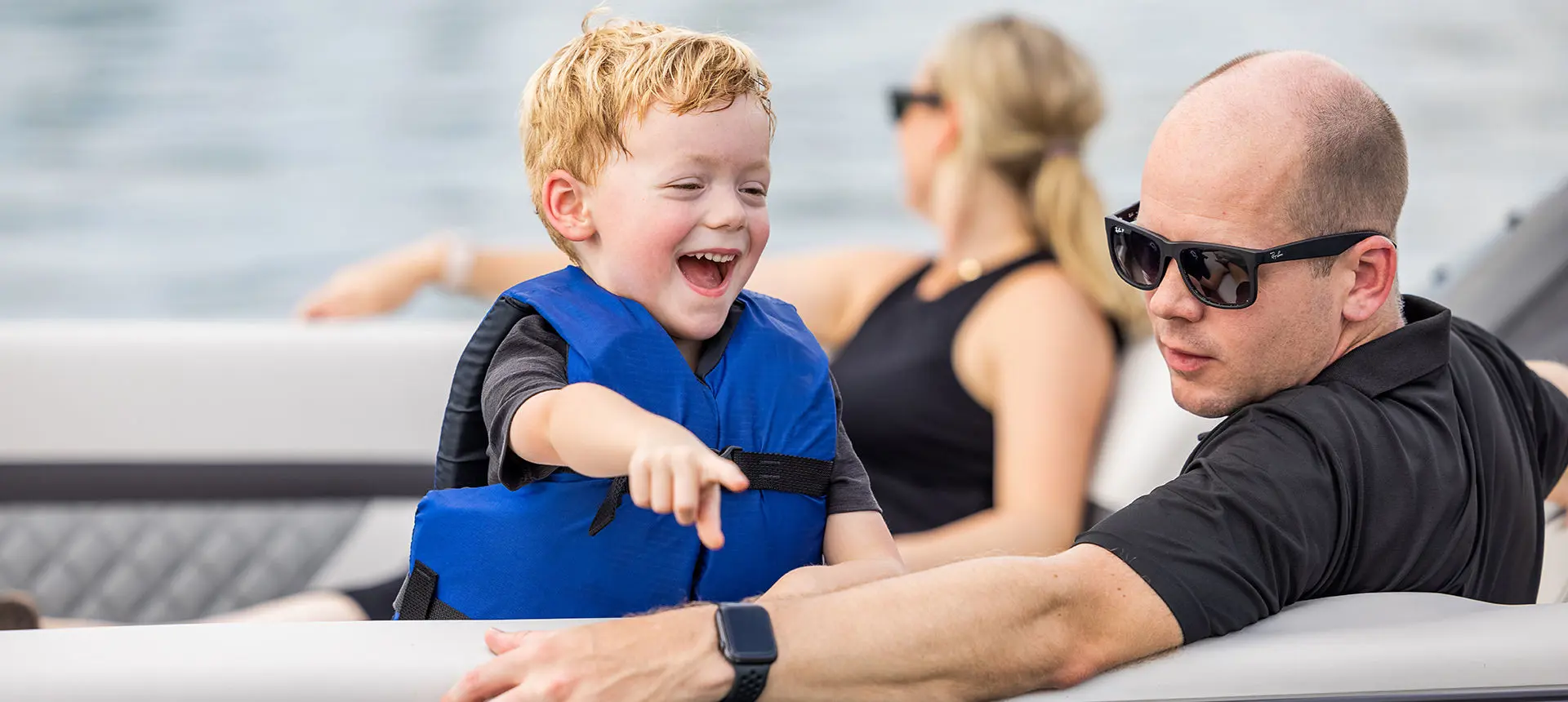 young boy and dad having fun on a godfrey aquapatio entertainment pontoon