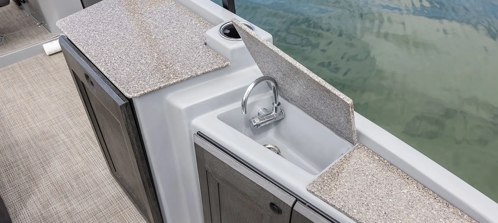 Integrated sink on a Godfrey AquaPatio Entertainment pontoon boat.