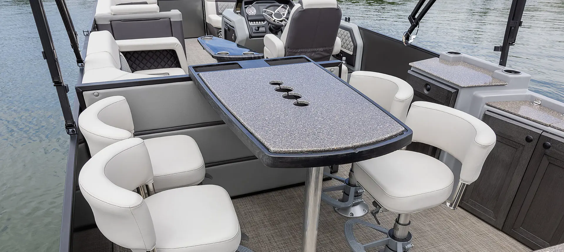 Stern table and bar stools on a Godfrey AquaPatio Entertainment pontoon boat.