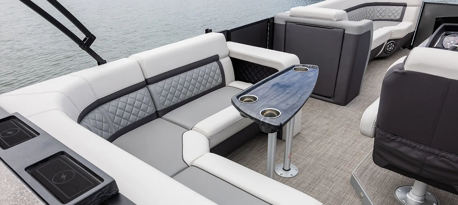Midship couch and table on a Godfrey AquaPatio Entertainment pontoon boat.