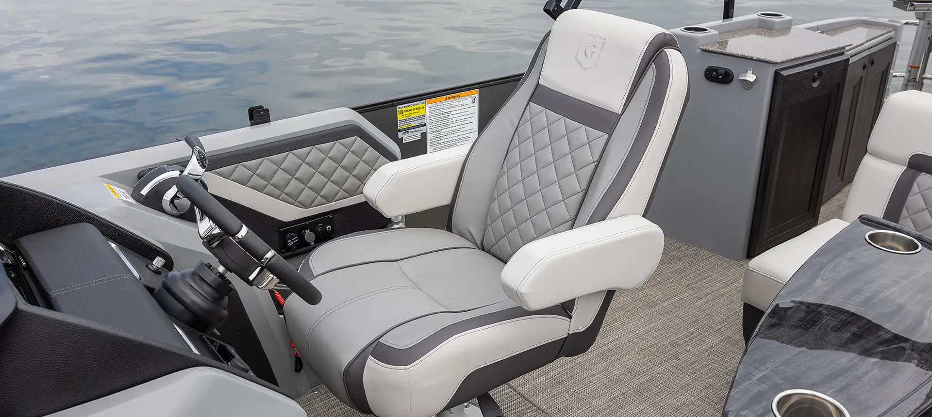 captain's chair at the helm on a godfrey aquapatio entertainment pontoon