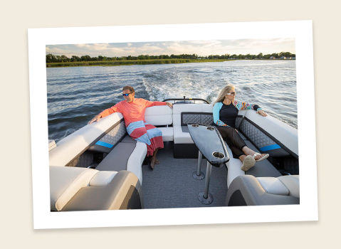 couple relaxing in the ultra lounge on a godfrey aquapatio lounge pontoon