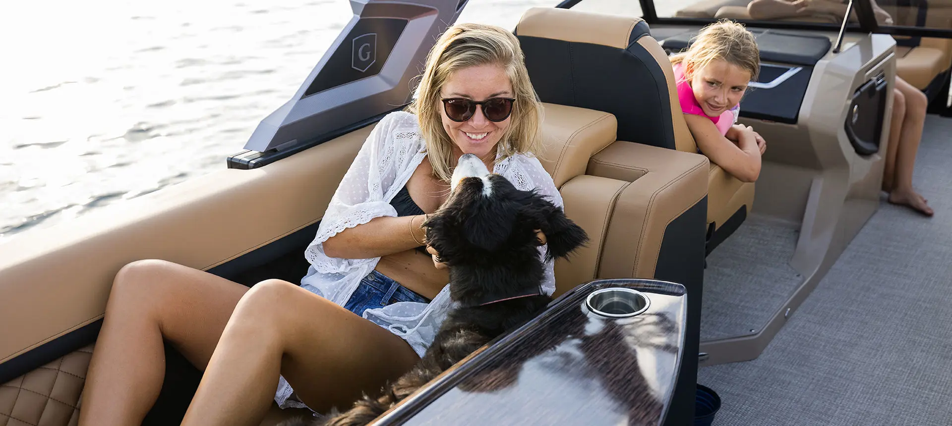 woman and her dog on a godfrey aquapatio lounge pontoon
