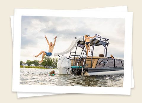 man using the slide on a godfrey aquapatio sundeck pontoon