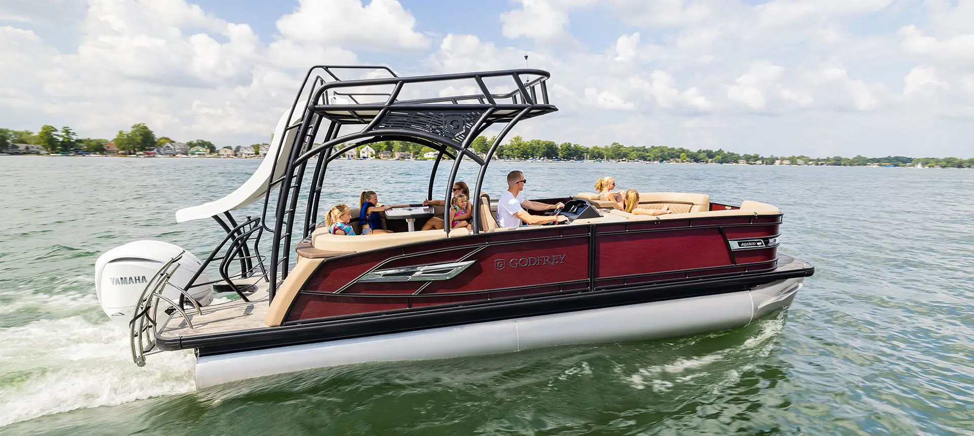 godfrey aquapatio sundeck pontoon cruising on a lake