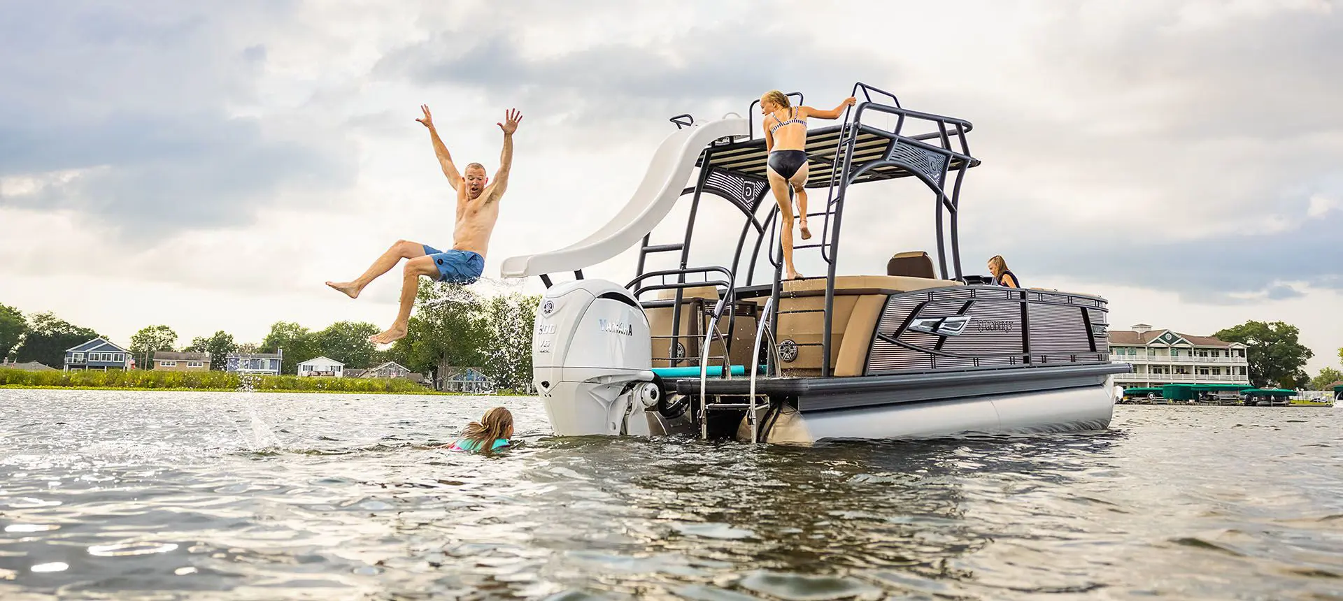 man using a slide on a godfrey aquapatio sundeck pontoon