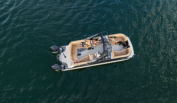 godfrey aquapatio twin pontoon floating on a lake