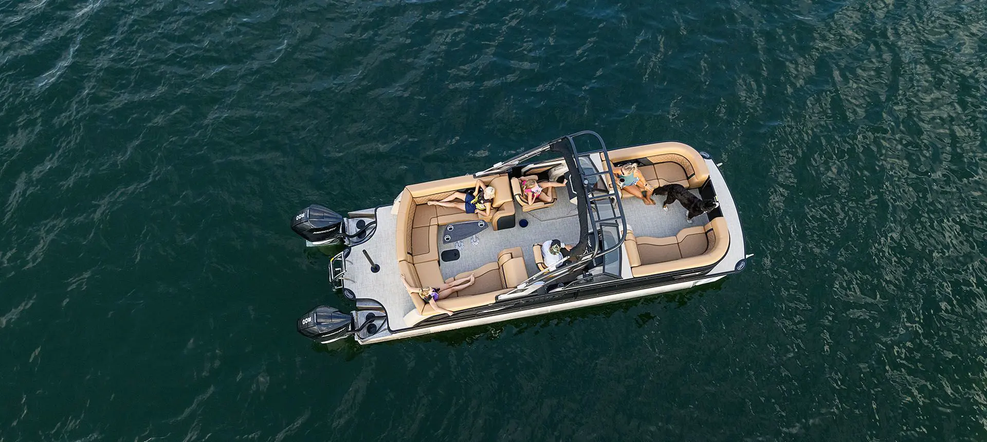 aerial view of a godfrey aquapatio winshield twin tritoon floating on a lake