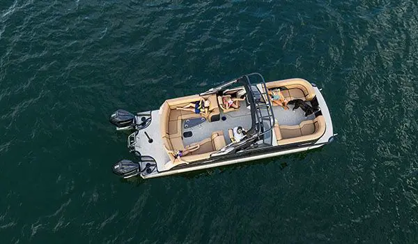 aerial view of a godfrey aquapatio winshield twin tritoon floating on a lake