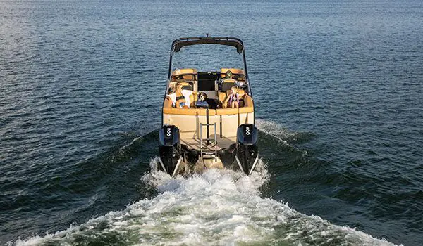 stern view of a godfrey aquapatio windshield pontoon on a lake