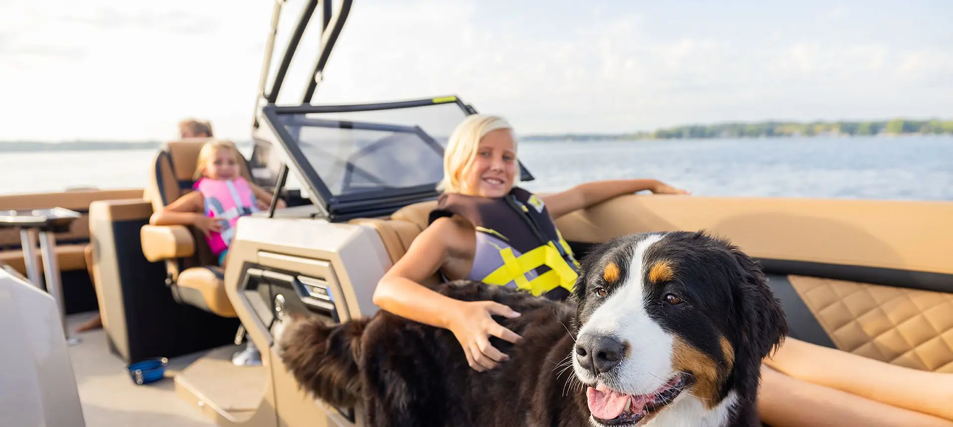 girl and her dog smiling on a godfrey aquapatio winshield pontoon