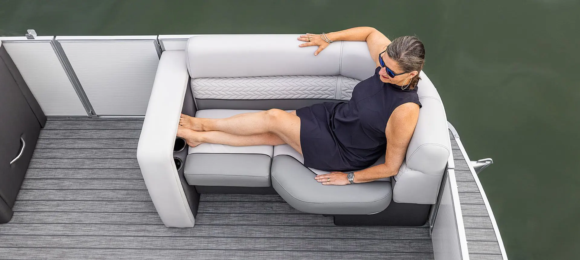 woman relaxing on a godfrey monaco cruise pontoon