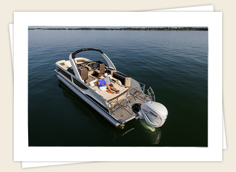 couple relaxing on a godfrey sanpan lounge pontoon