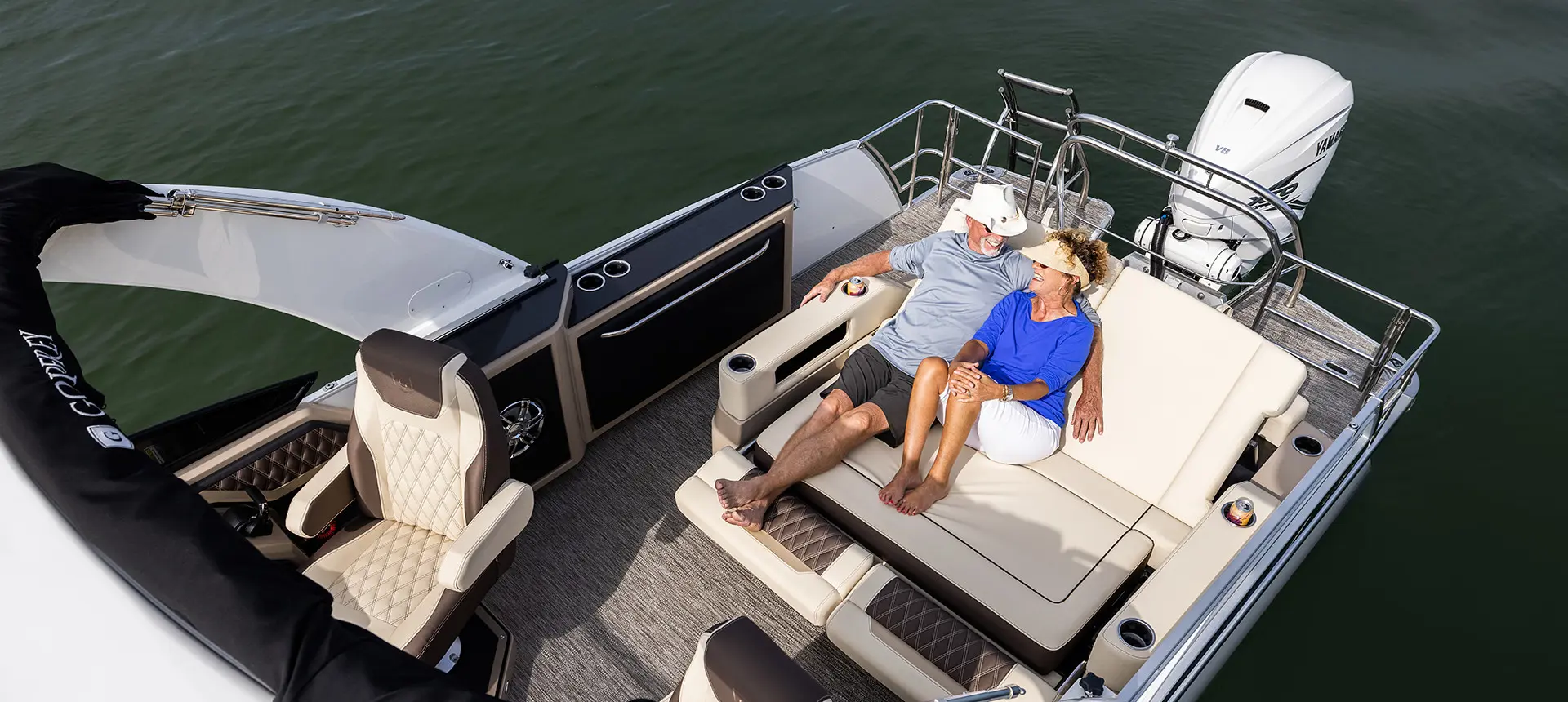 couple relaxing on a godfrey sanpan lounge pontoon