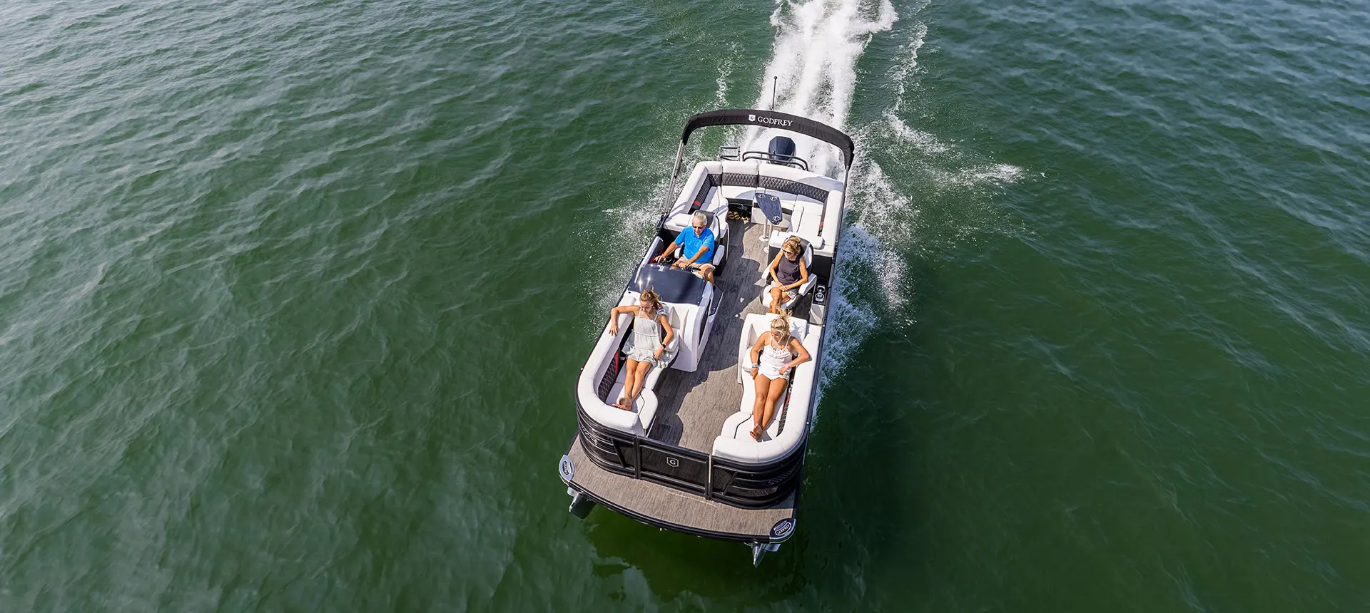 godfrey sanpan lounge pontoon cruising on a lake