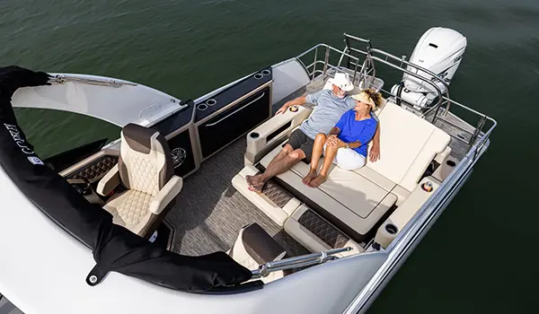 couple relaxing on a godfrey sanpan lounge pontoon