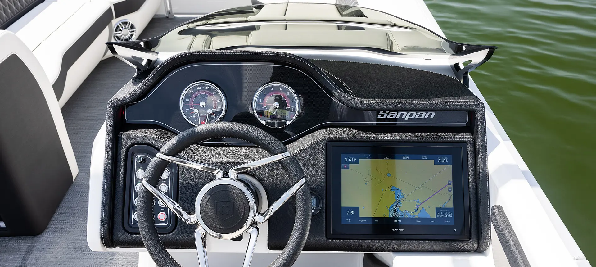 steering wheel, guages, and garmin gps at the helm on a godfrey sanpan split bench pontoon