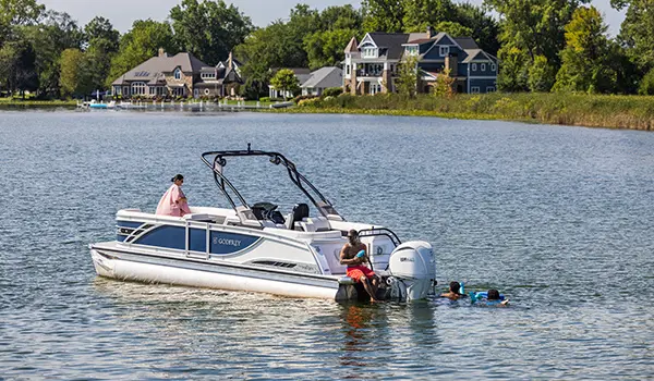 family swimming near their godfrey sanpan split bench pontoon