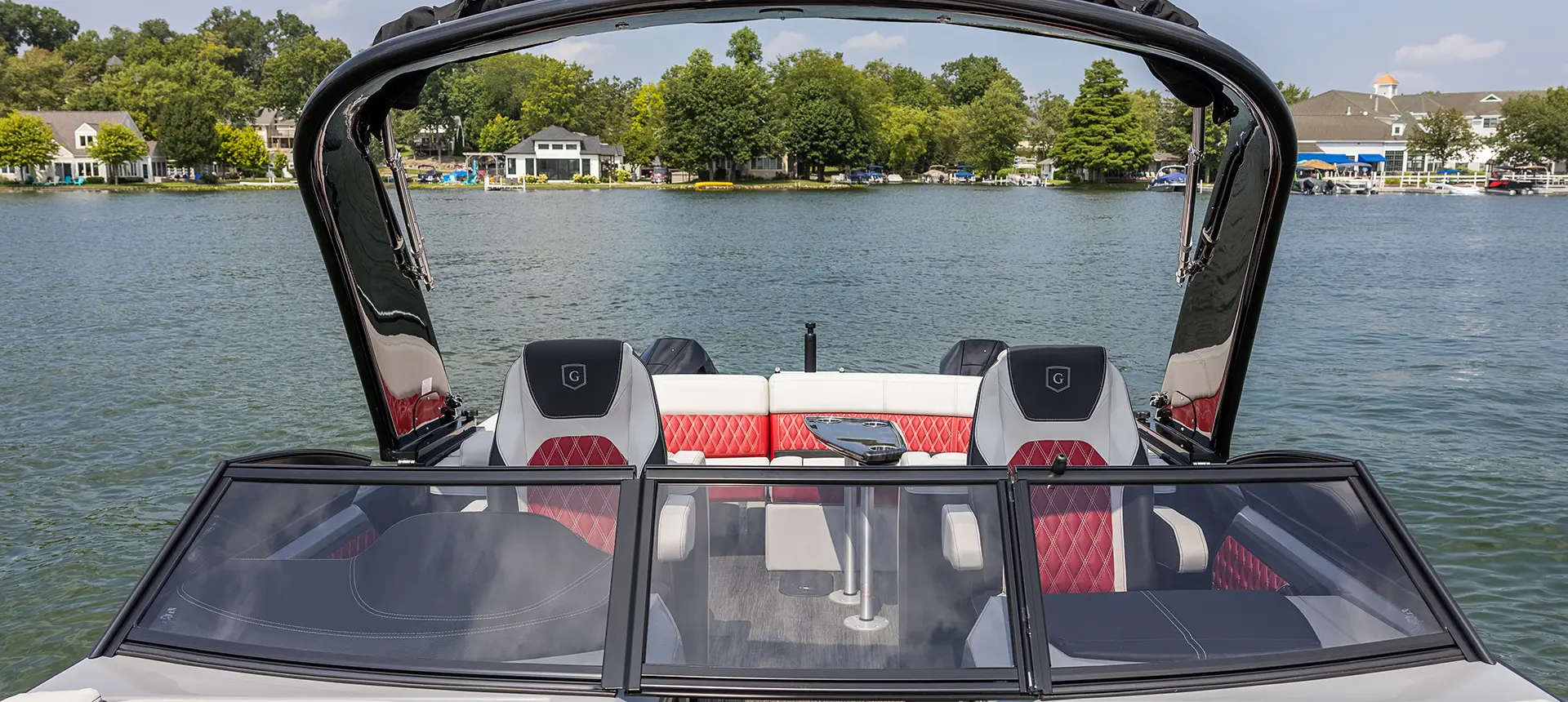 Windshield, sport arch and co-captain's chairs on a Godfrey Sanpan Twin tritoon.