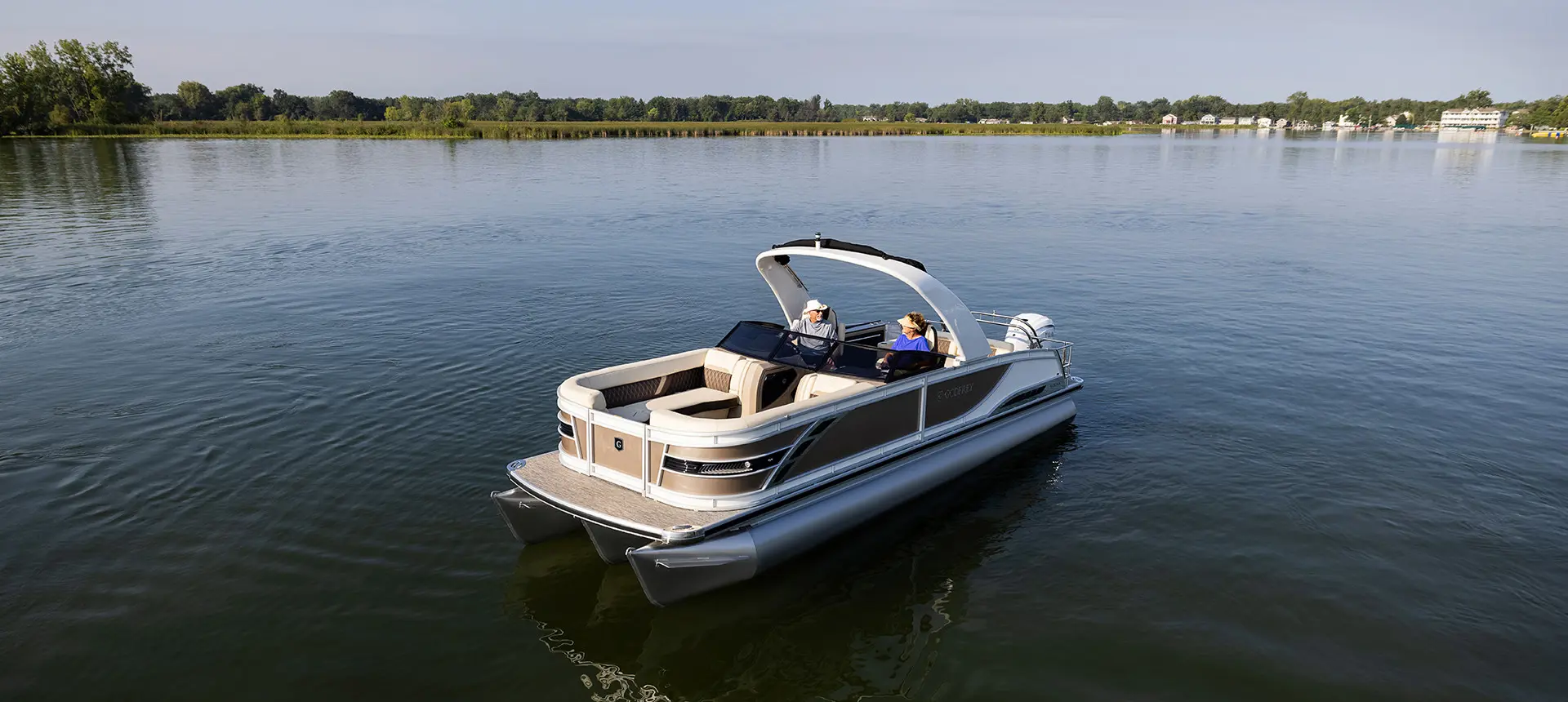 godfrey sanpan windshield pontoon floating on a lake