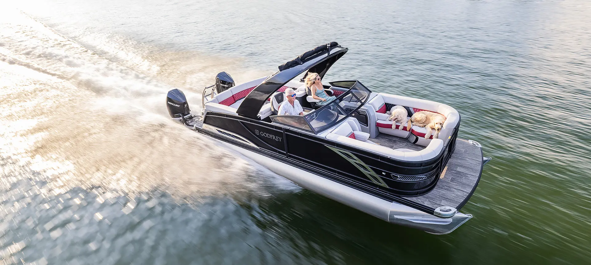 godfrey sanpan windshield pontoon speeding across a lake
