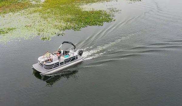 aerial view of a godfrey xperience cruise pontoon cruising on a lake